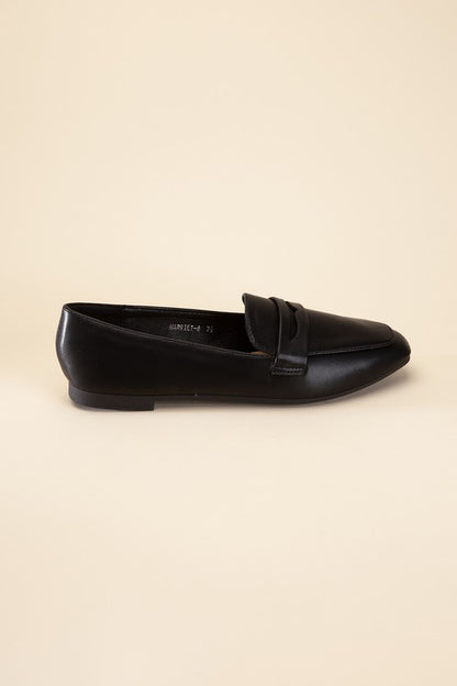 Shophouse Northwest black leather Harriet-8 slip on penny flats shoes side profile on beige