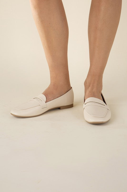 Shophouse Northwest cream Harriet-8 slip on penny flats shoes shown on model feet with low heel