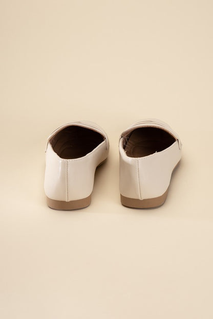 Harriet-8 slip on penny flats shoes by Shophouse Northwest in cream leather shown from back on beige background
