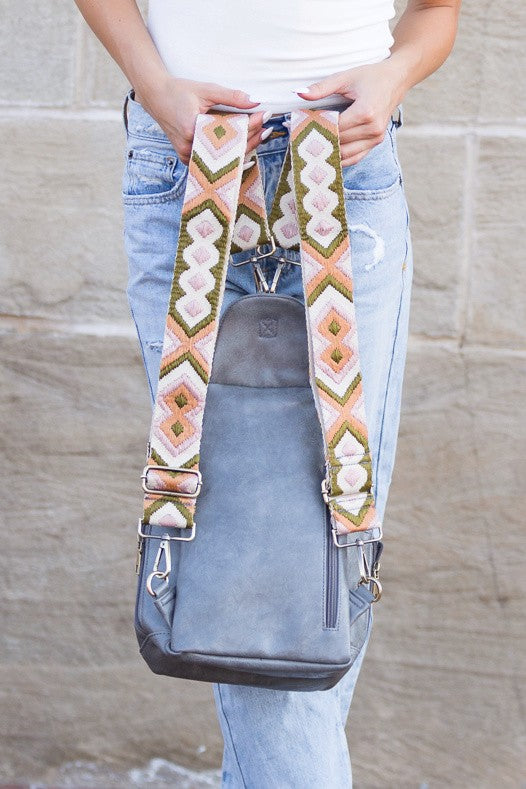 Alba backpack sling convertible bag gray leather crossbody with adjustable patterned straps shown worn