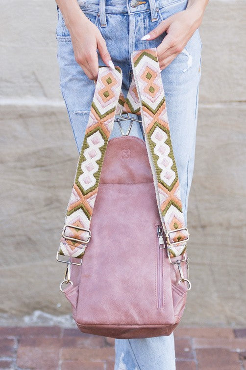 Alba backpack sling convertible bag dusty rose leather with patterned woven straps worn with jeans
