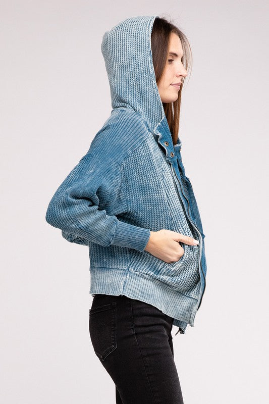 Shophouse Northwest acid wash waffle zip up jacket in blue on model with hood up and hand in pocket