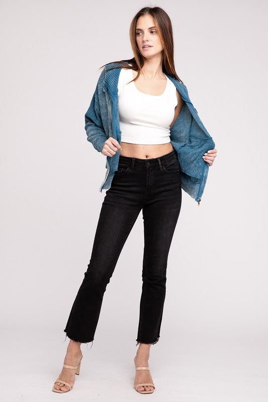Shophouse Northwest model wearing acid wash waffle zip up jacket open over white crop top with black jeans