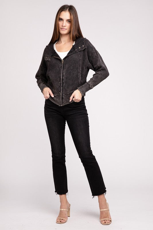 Shophouse Northwest model wearing acid wash waffle zip up jacket in charcoal over white tank with black cropped jeans and heels