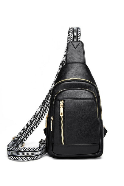 Shophouse Northwest Genevive leather sling crossbody bag black pebbled leather with gold zippers and wide patterned strap