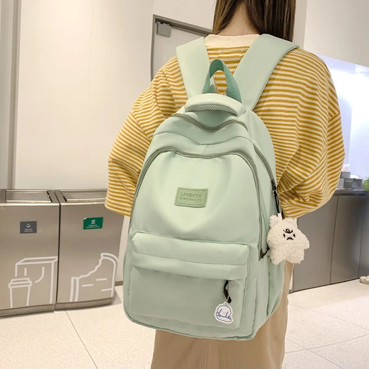Mint green waterproof girls laptop backpack with adjustable straps and fluffy keychain