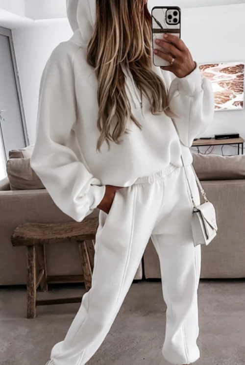 Stylish model wearing a white cotton tracksuit set with a cozy hoodie and matching sweatpants