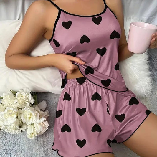 Women's heart print pajama set in pink with black hearts, perfect for comfortable loungewear